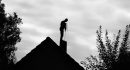 Contour of a chimney sweep, silhouetted against the light.Black and white photo.